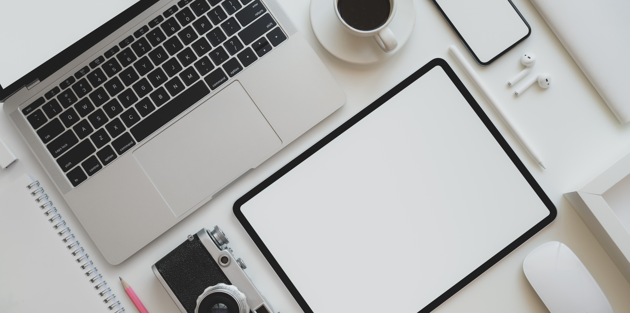 White Ipad Beside White Ceramic Mug on White Table